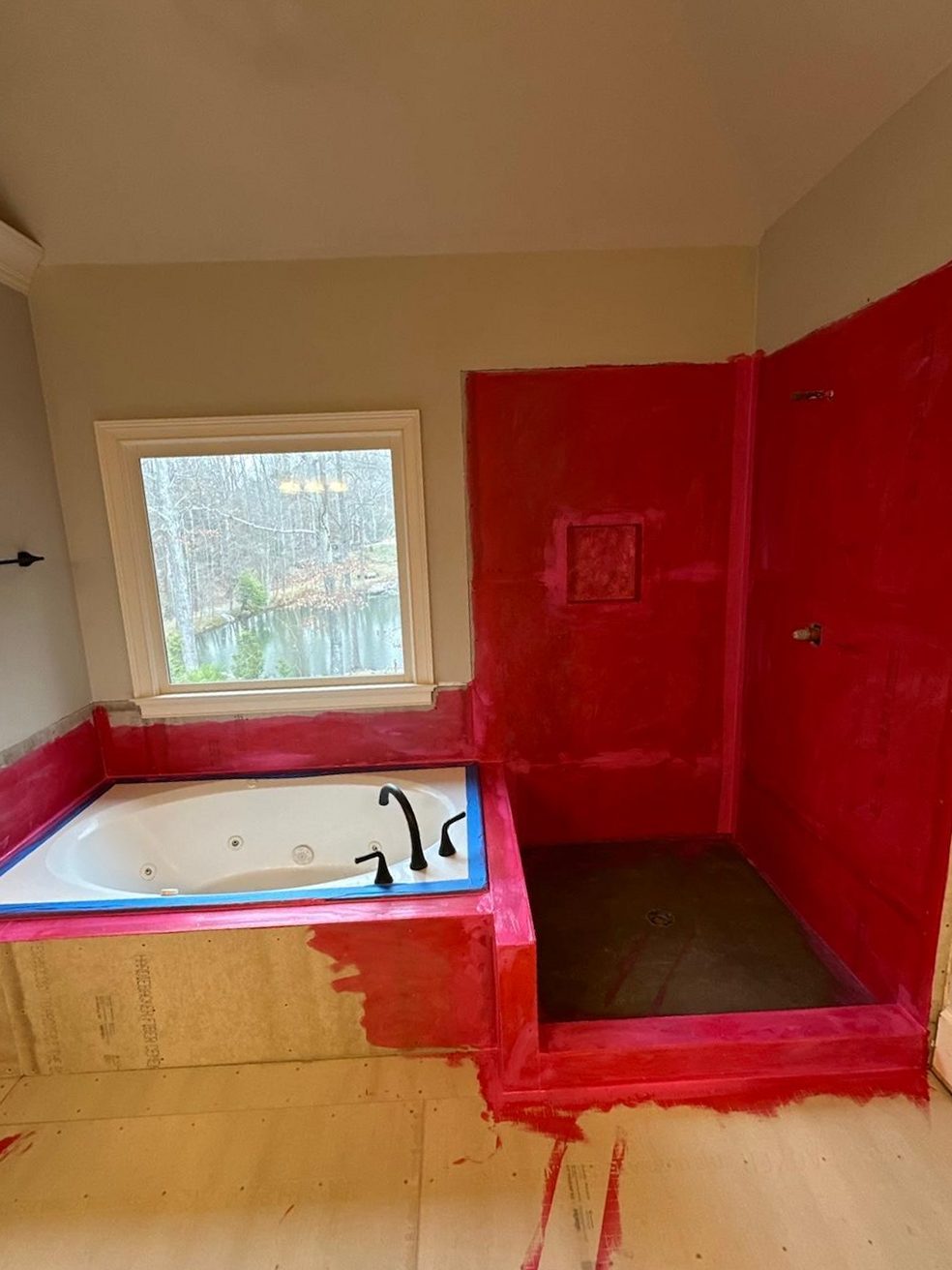 Shower before tile: waterproofing membrane applied to walls and pan