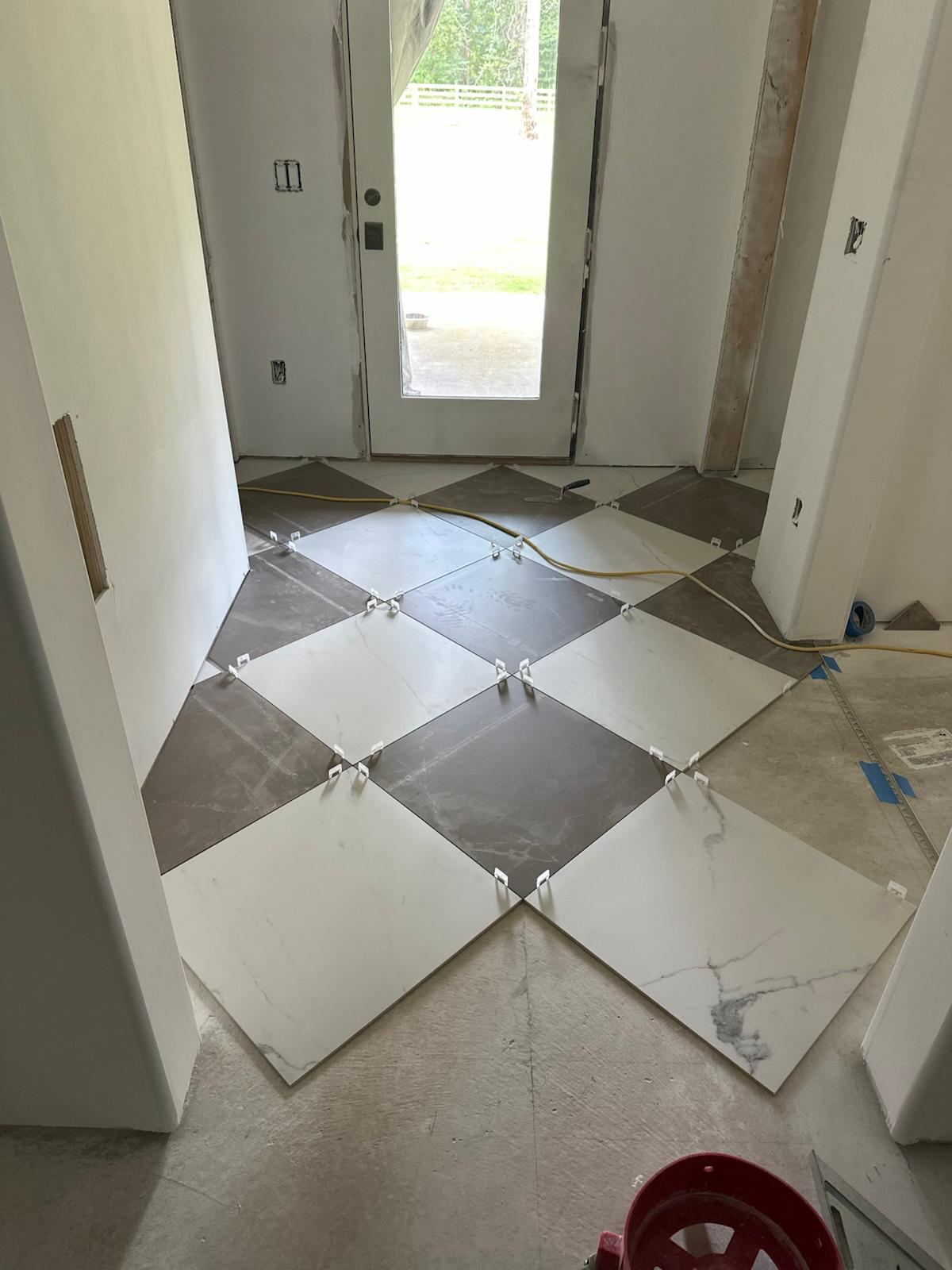 Diagonal checkerboard porcelain floor tile at a front entryway