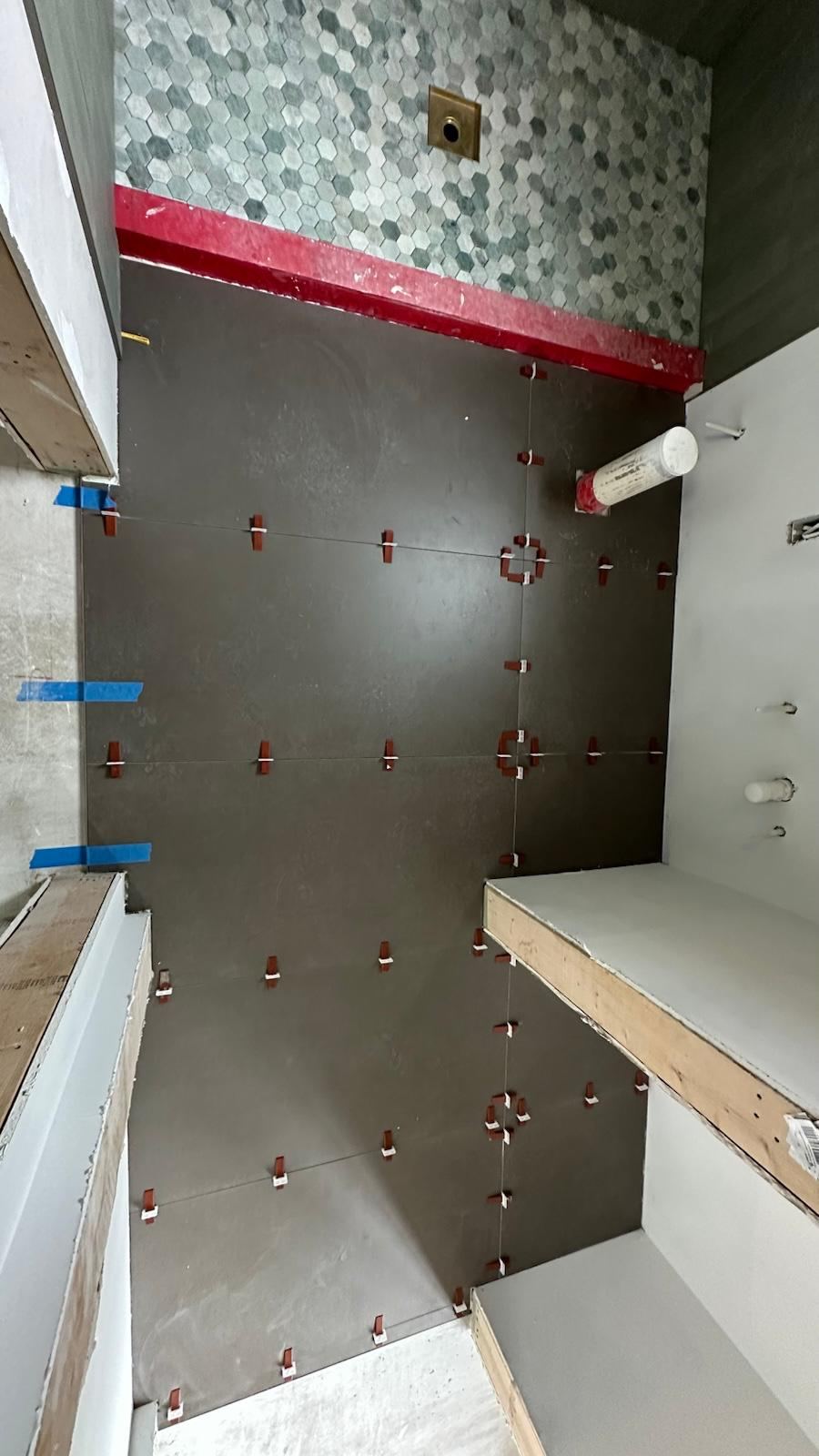 Marble hexagon mosaic accent wall in a shower